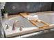 Close-up of modern tub with bamboo tray and towels, perfect for relaxation at 4890 Benthaven E Dr, Bargersville, IN 46106