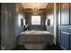 Well-lit bathroom with a built-in tub, tiled walls, and modern chandelier at 4890 Benthaven E Dr, Bargersville, IN 46106