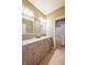 Bathroom featuring a double vanity with granite countertop and tiled flooring at 4890 Benthaven E Dr, Bargersville, IN 46106