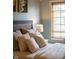 Close-up of bed with neutral bedding, pillows, and natural light from window at 4890 Benthaven E Dr, Bargersville, IN 46106