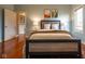 Bright bedroom with hardwood floors, a cozy bed, and ample natural light at 4890 Benthaven E Dr, Bargersville, IN 46106