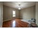 Empty room with hardwood flooring, a chandelier, and a large window at 4890 Benthaven E Dr, Bargersville, IN 46106