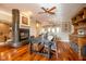 Dining area with hardwood floors, fireplace, and view of kitchen at 4890 Benthaven E Dr, Bargersville, IN 46106