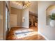 Welcoming foyer showcasing an ornate chandelier, hardwood floors with mosaic and views into the living area at 4890 Benthaven E Dr, Bargersville, IN 46106