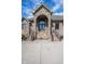 Close up of the arched stone entrance, featuring double doors and a concrete driveway with stairs at 4890 Benthaven E Dr, Bargersville, IN 46106