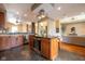 Open kitchen featuring a central island with a wine cooler, custom lighting, and stainless steel appliances at 4890 Benthaven E Dr, Bargersville, IN 46106