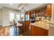 Modern kitchen with stainless steel appliances, an island with bar seating, and granite countertops at 4890 Benthaven E Dr, Bargersville, IN 46106