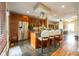 Modern kitchen with stainless steel appliances, an island with bar seating, and dark cabinetry at 4890 Benthaven E Dr, Bargersville, IN 46106