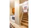 Hallway featuring the stairs to the upper level and laundry with cabinets at 4890 Benthaven E Dr, Bargersville, IN 46106