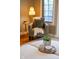 Cozy nook with a cushioned chair, decorative pillow, lamp, and window with blinds at 4890 Benthaven E Dr, Bargersville, IN 46106