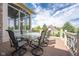Outdoor dining area featuring a large glass-top table with seating, perfect for entertaining and enjoying the view at 4890 Benthaven E Dr, Bargersville, IN 46106