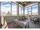 Screened-in patio with natural light, comfortable seating, and views of the surrounding landscape at 4890 Benthaven E Dr, Bargersville, IN 46106
