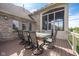 Outdoor dining area with a glass-top table and seating for eight, ideal for entertaining and enjoying meals al fresco at 4890 Benthaven E Dr, Bargersville, IN 46106