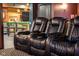 Close up of luxury theater seating and view of the basement bar area at 4890 Benthaven E Dr, Bargersville, IN 46106