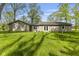 Expansive backyard featuring lush green grass and the rear view of this single-story house at 5039 Five Points Rd, Indianapolis, IN 46239