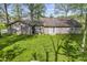 Back of the home with mature trees and lush green lawn at 5039 Five Points Rd, Indianapolis, IN 46239