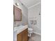 Charming powder room featuring floral wallpaper, a classic vanity and a framed mirror at 5039 Five Points Rd, Indianapolis, IN 46239