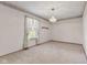 Bright, carpeted bedroom with a large window and simple decor at 5039 Five Points Rd, Indianapolis, IN 46239