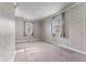 Room with wallpapered walls, two windows with curtains and neutral carpet flooring at 5039 Five Points Rd, Indianapolis, IN 46239