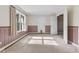Inviting bedroom with soft carpet, a window, and an open doorway to another room at 5039 Five Points Rd, Indianapolis, IN 46239