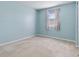 A bright bedroom features a window with curtains and neutral carpet flooring at 5039 Five Points Rd, Indianapolis, IN 46239