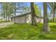 Charming home with attached two-car garage and a lush green lawn surrounded by mature trees at 5039 Five Points Rd, Indianapolis, IN 46239