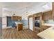 Spacious kitchen with wooden cabinets, laminate flooring, skylight and an island sink at 5039 Five Points Rd, Indianapolis, IN 46239