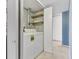 Functional laundry area equipped with a washer, dryer, and open shelving at 5039 Five Points Rd, Indianapolis, IN 46239