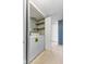 Bright laundry room with white washer and dryer, accompanied by shelving and patterned wallpaper at 5039 Five Points Rd, Indianapolis, IN 46239
