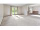 Bright, airy living room with large windows and French doors leading to the backyard at 5039 Five Points Rd, Indianapolis, IN 46239