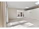Open-concept living room featuring neutral walls, plush carpet, and natural light from skylights at 5039 Five Points Rd, Indianapolis, IN 46239
