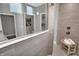 Contemporary bathroom with a glass-enclosed shower featuring neutral tiling, adjacent toilet room, and bench seating at 5062 Foxley Park Ln, Avon, IN 46123