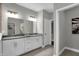 Stylish bathroom featuring a double sink vanity, a large mirror, modern lighting, and a walk-in closet at 5062 Foxley Park Ln, Avon, IN 46123
