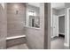 Luxurious bathroom featuring a tiled shower with a built-in bench, modern fixtures, and contemporary design at 5062 Foxley Park Ln, Avon, IN 46123