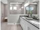 Modern bathroom featuring a double vanity, a spacious glass-enclosed shower, and elegant fixtures at 5062 Foxley Park Ln, Avon, IN 46123