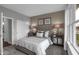 Cozy bedroom with neutral tones, ample lighting, and a view through the window at 5062 Foxley Park Ln, Avon, IN 46123