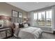 Comfortable bedroom with a large window view, patterned bedding, and modern décor at 5062 Foxley Park Ln, Avon, IN 46123