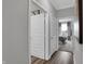 Hallway leading into a bedroom with white trim and doors at 5062 Foxley Park Ln, Avon, IN 46123