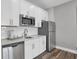 Modern kitchen with white cabinets, stainless steel appliances, and sleek countertops at 5062 Foxley Park Ln, Avon, IN 46123