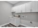 Functional laundry room with ample cabinet space, sink, modern appliances hook-ups, and efficient design at 5062 Foxley Park Ln, Avon, IN 46123
