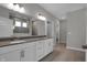 Bathroom with dual sink vanity, granite countertop, and large mirror at 5127 Foxley Park Ln, Avon, IN 46123