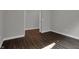 Well-lit bedroom featuring hardwood floors and an open doorway to another room at 5127 Foxley Park Ln, Avon, IN 46123