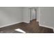 Bedroom with hardwood floors, white trim, and a doorway leading to a closet or bathroom at 5127 Foxley Park Ln, Avon, IN 46123