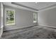 Well lit bedroom featuring plush carpet and large windows overlooking a wooded area at 5127 Foxley Park Ln, Avon, IN 46123