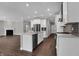 Open-concept kitchen with stainless appliances, white cabinetry, and center island at 5127 Foxley Park Ln, Avon, IN 46123