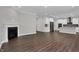 Open floor plan with living room featuring fireplace and kitchen at 5127 Foxley Park Ln, Avon, IN 46123