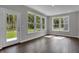 Sunroom featuring an exterior door and many windows bringing an abundance of light and nature views at 5127 Foxley Park Ln, Avon, IN 46123