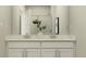Bright bathroom with a double vanity and a decorative sprig of greenery at 5208 Foxley Park Ln, Avon, IN 46123