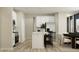 Bright kitchen with stainless steel appliances, white cabinets, an island with seating and adjacent dining area at 5208 Foxley Park Ln, Avon, IN 46123