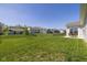 Large backyard featuring lush grass, a quaint patio area with dining, and a peaceful atmosphere at 5375 Citadel Dr, Noblesville, IN 46062